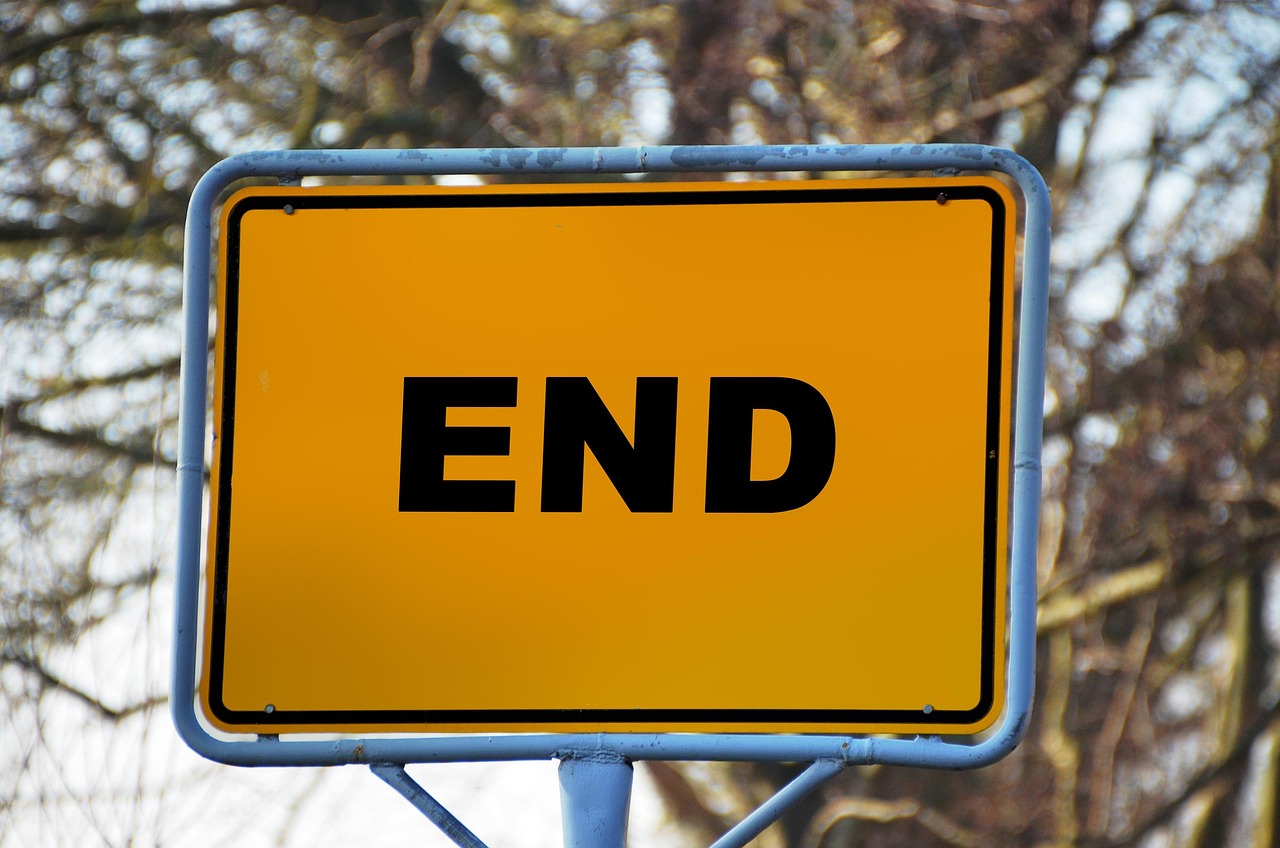 Photograph of signpost with text "END"